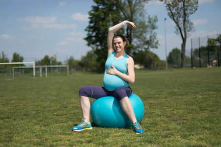 Pregnant woman with fitness ballの写真素材