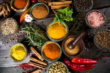 Spices and herbs in wooden bowls. Food and cuisine ingredients