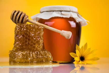 Jar full of fresh honey and honeycombsの写真素材