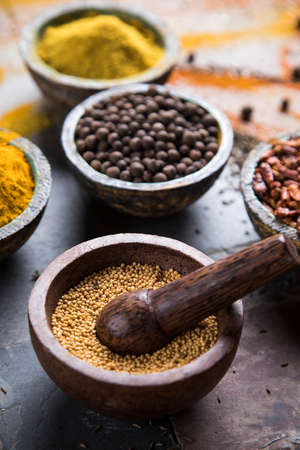 Hot spices in wooden bowlsの写真素材