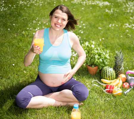 Beautiful pregnant woman at fitness gym relaxedの写真素材