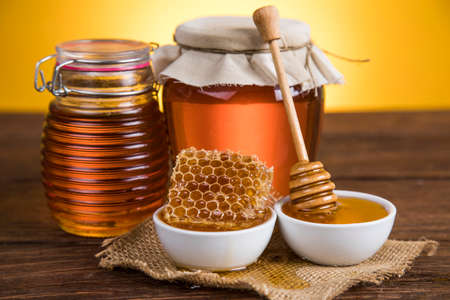 Jar full of fresh honey and honeycombsの写真素材