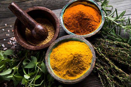 Wooden table of colorful spicesの写真素材