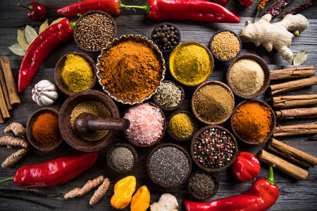 Variety of spices and herbs on kitchen tableの写真素材