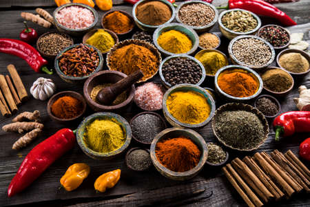 Variety of spices and herbs on kitchen tableの写真素材