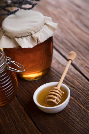 Fresh honey on wooden tableの写真素材