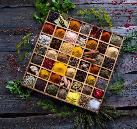 Wooden box with spices and herbsの写真素材