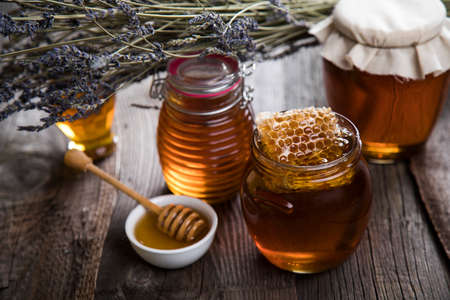 Jar of honey with honeycombの写真素材