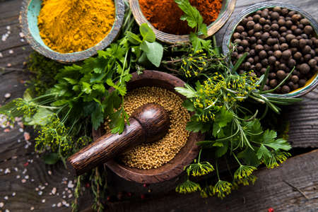 Hot spices in wooden bowlsの写真素材