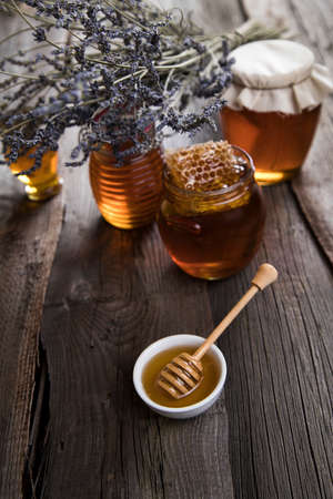 Jar of honey with honeycombの写真素材