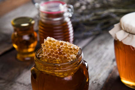 Jar of honey with honeycombの写真素材
