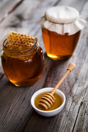 Jar full of fresh honey and honeycombsの写真素材