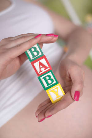 Wooden toy cubes with letters, Baby, Pregnancy conceptの写真素材