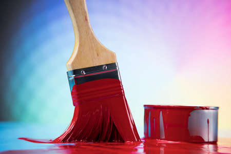 Metal tin cans with color paint and paintbrushの写真素材