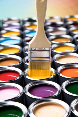 Metal tin cans with color paint and paintbrushの写真素材