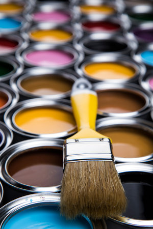 Paintbrush on cans with colorの写真素材