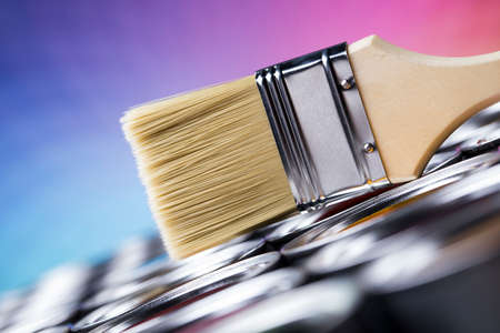 Paintbrush on cans with colorの写真素材