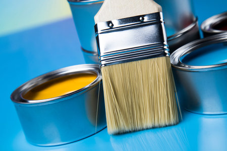 Tin metal cans with color paint and paintbrushの写真素材