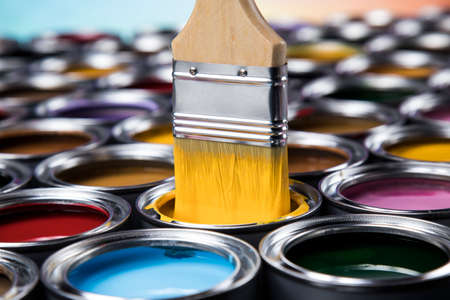 Paintbrush on cans with colorの写真素材