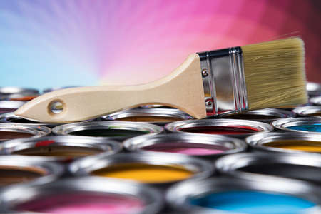 Colorful paint cans with paintbrushの写真素材