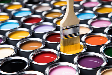 Colorful paint cans with paintbrushの写真素材