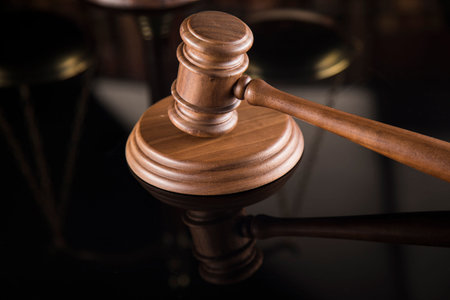 Law theme, mallet of the judge, mirror reflection background