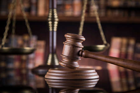 Law theme, mallet of judge, wooden gavel, mirror reflection backgroundの写真素材