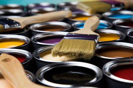 Colorful paint cans with paintbrushの写真素材