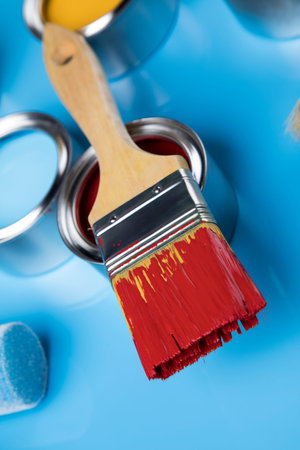 Paintbrush on cans with color