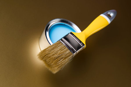 Paintbrush on cans with color