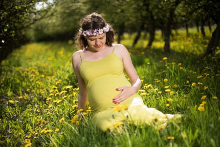 Blooming Garden, Beautiful pregnant womanの写真素材