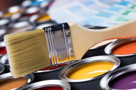 Tin cans with paint, brushes and bright palette of colorsの写真素材