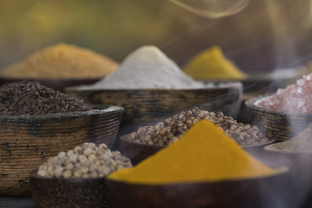 Assorted Spices and wooden bowl of smokeの写真素材