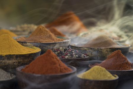 Assorted Spices and wooden bowl of smokeの写真素材