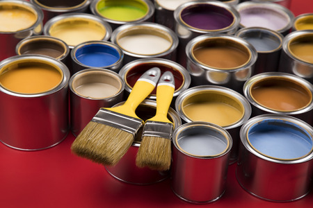 Open buckets with a paint and brush, red backgroundの写真素材