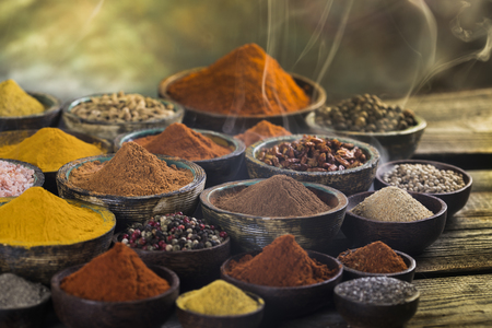 Assorted Spices and wooden bowl of smokeの写真素材