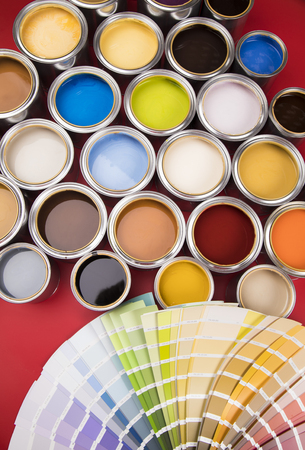 Open buckets with a paint and brush, red backgroundの写真素材