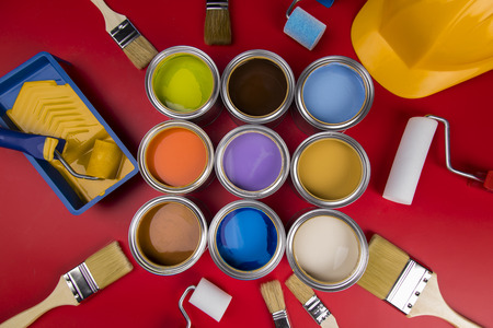 Open buckets with a paint and brush, red backgroundの写真素材