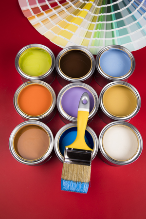 Paintbrush on cans with red backgroundの写真素材