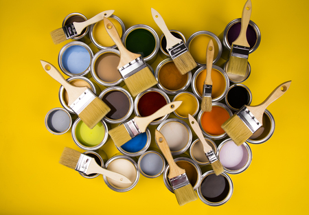 Paint can and paintbrush, yellow backgroundの写真素材