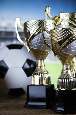 Cups of winners award on white podium, sport backgroundの写真素材