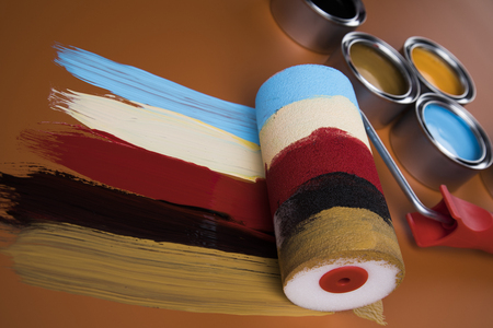 Metal tin cans with color paint and paintbrushの写真素材