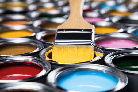 Metal tin cans with color paint and paintbrush
