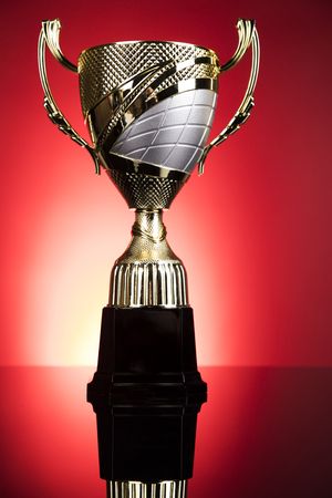 Cups of winners award on white podium, sport backgroundの写真素材