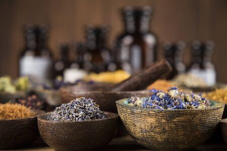 Homeopathy, herbal medicine on wooden tableの写真素材