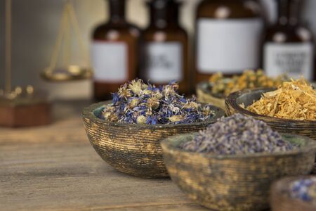 Fresh medicinal herbs on wooden backgroundの写真素材