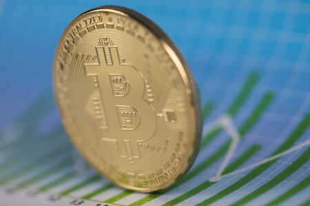 Gold Bitcoin on the background of the chartの写真素材