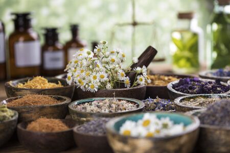 Homeopathy, herbal medicine on wooden tableの写真素材