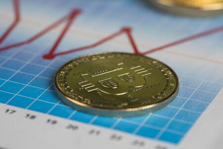 Golden Bitcoin Coin, virtual money, financial chartの写真素材