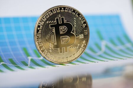 Gold Bitcoin on the background of the chartの写真素材